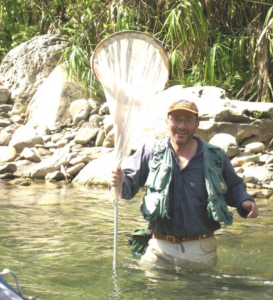 Nathan Schiff Standing in a body of water holding up a net