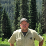 A portrait of Rex Thompson in the forest