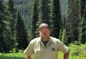 A portrait of Rex Thompson in the forest