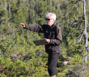 Robert DeVelice working in a forested area