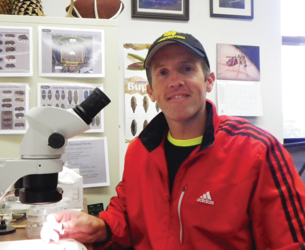 Ryan Hanavan by a microscope
