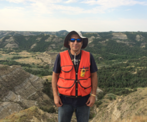 Sabry Hanna standing on top of a mountain