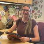 A portrait of Sally Davis at her desk