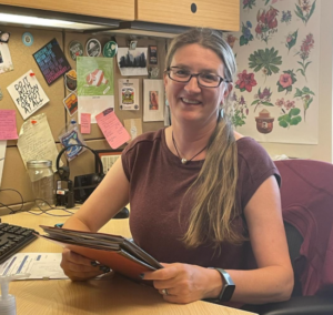 A portrait of Sally Davis at her desk