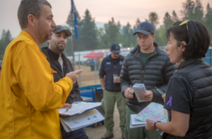 Shaniko Cowie meeting with a group of coworkers outside