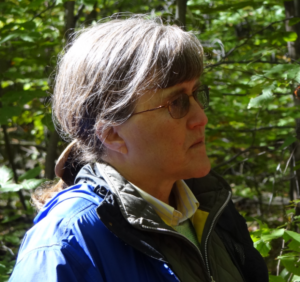 Dr. Stout in profile in a forest