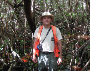 Tom Brandeis in protective gear in a mangrove forest