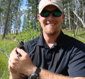 Mr. Dickerson holds a small bird.