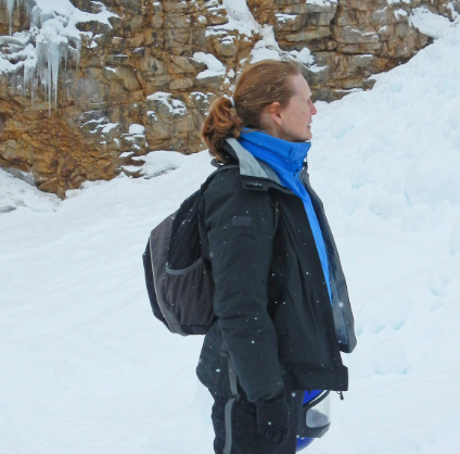 Ms. Raley stands in profile in the snow