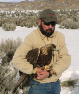 Mr. Lopez holds an eagle.