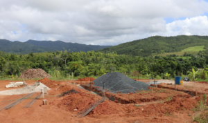 Land being prepared for a foundation with forest in the background