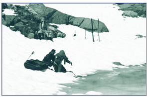 Scientist walking the shoreline in a snowy area