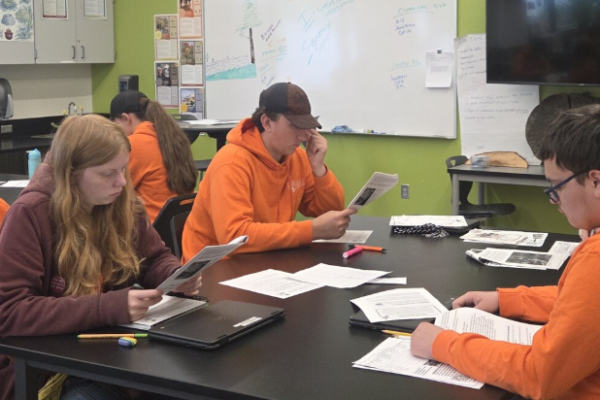 A classroom of forestry students reviews a new publication