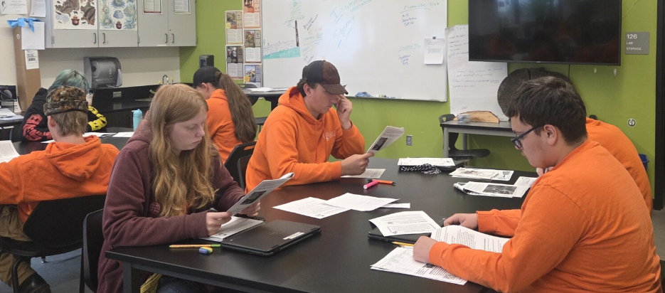 A classroom of forestry students reviews a new publication