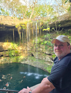 Stacy Drury stands above a cenote.